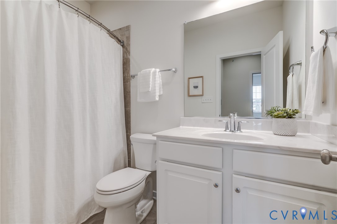 2006 Libbie Lake W Street, Unit B Richmond, VA 23230 - Photo 36 of 43 a bathroom with a sink a toilet and shower curtain