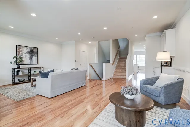 a living room with furniture and wooden floor