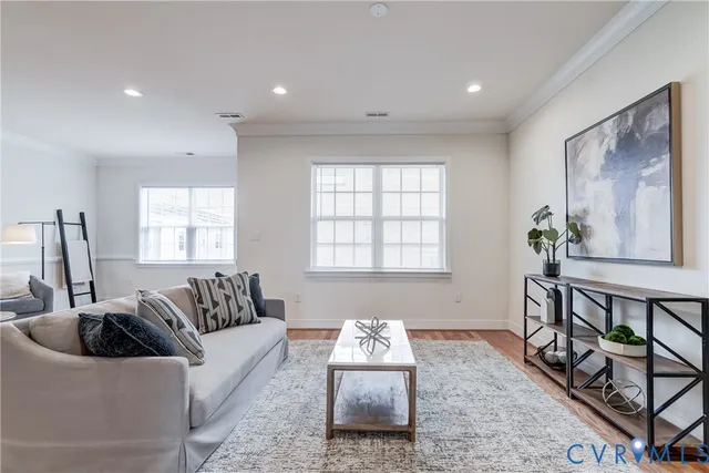 a living room with furniture and wooden floor