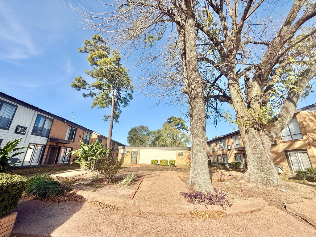 a view of a house with a tree in the background