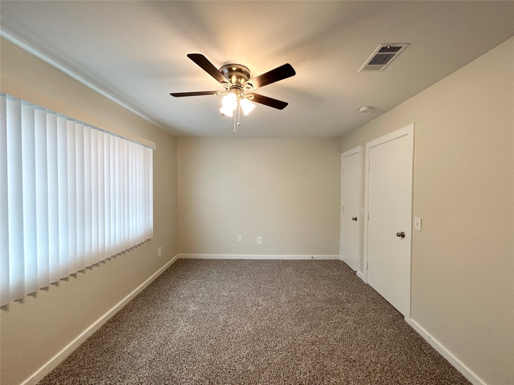 3629 North MacGregor Way, Unit 131 Houston, TX 77004 - Photo 11 of 13 a view of an empty room with window and chandelier fan