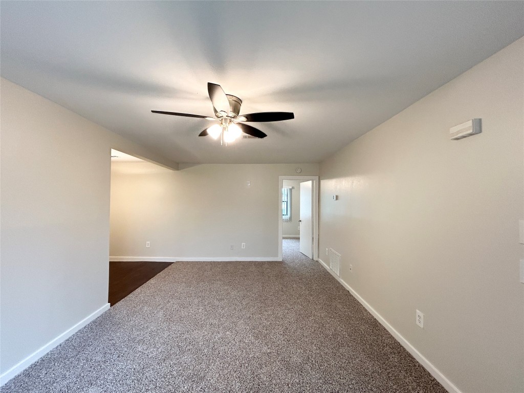 3629 North MacGregor Way, Unit 131 Houston, TX 77004 - Photo 2 of 13 an empty room with a ceiling fan and a window