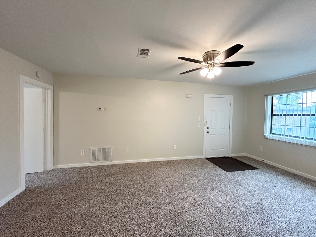3629 North MacGregor Way, Unit 131 Houston, TX 77004 - Photo 3 of 13 a view of an empty room with a ceiling fan and a window