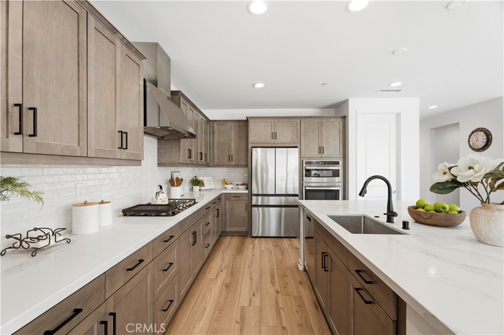 18100 Tableau Way Saugus, CA 91350 - Photo 15 of 63 a kitchen with a sink a stove and cabinets