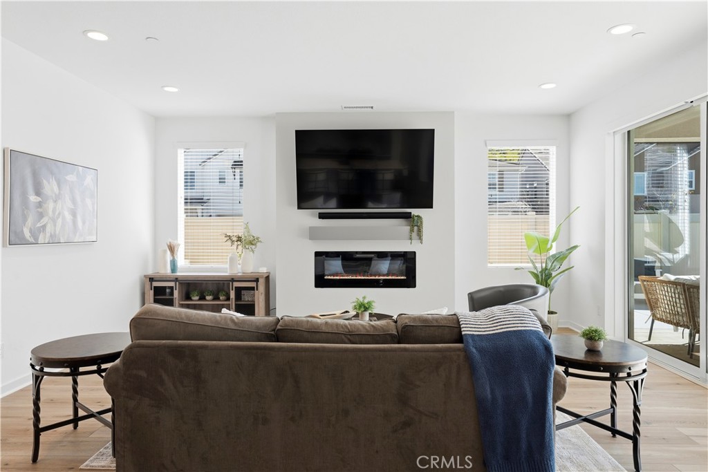 18100 Tableau Way Saugus, CA 91350 - Photo 19 of 63 a living room with furniture a flat screen tv and a fireplace