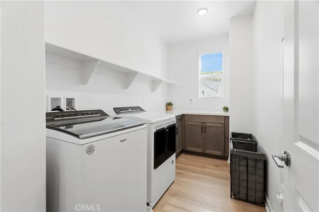 a large white kitchen with a sink and a refrigerator