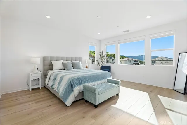 a view of a hallway with wooden floor and closet