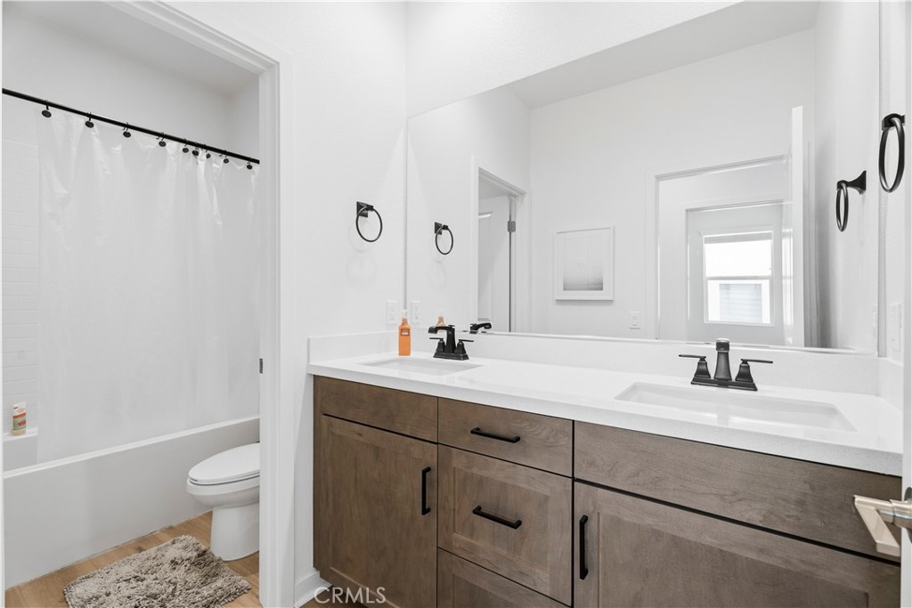18100 Tableau Way Saugus, CA 91350 - Photo 38 of 63 a bathroom with a double vanity sink toilet mirror and bathtub