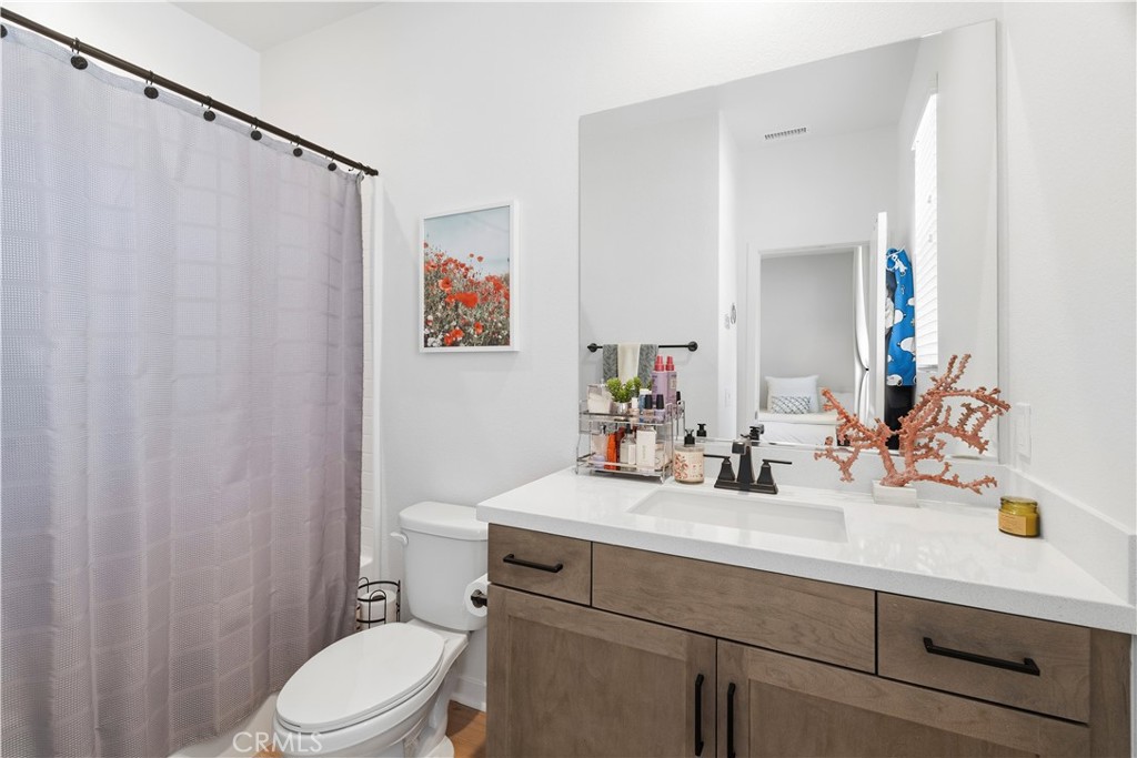 18100 Tableau Way Saugus, CA 91350 - Photo 40 of 63 a bathroom with a sink mirror vanity and toilet