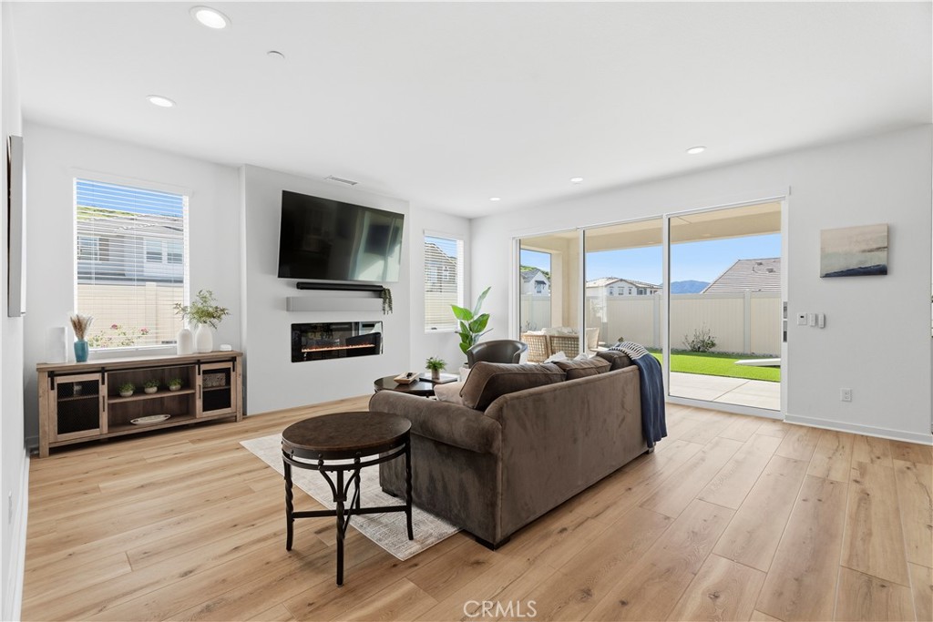 18100 Tableau Way Saugus, CA 91350 - Photo 8 of 63 a living room with furniture a flat screen tv and a fireplace