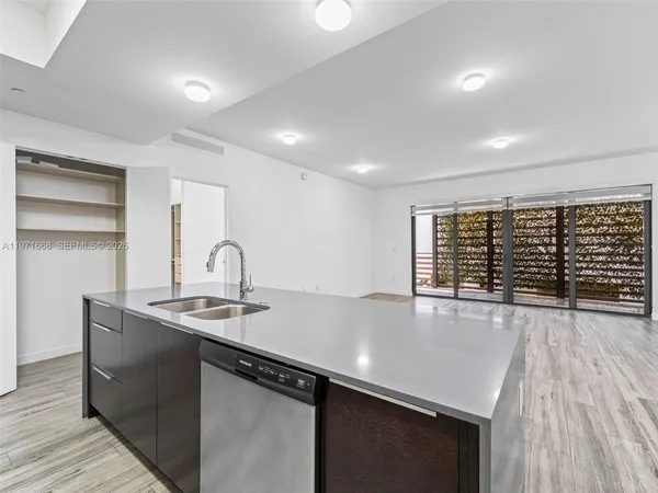 a kitchen with kitchen island a sink and wooden floor