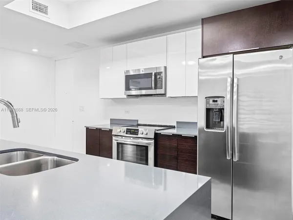 a kitchen with a refrigerator sink and microwave
