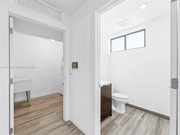 a bathroom with a toilet and a mirror
