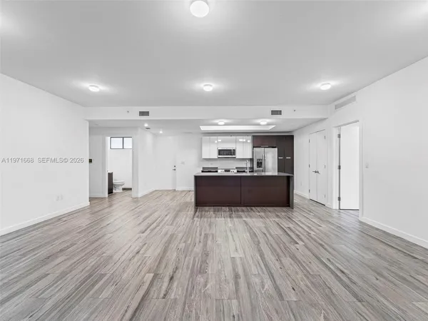 a view of kitchen and kitchen with wooden floor