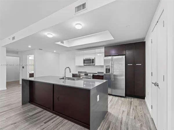 a kitchen with refrigerator and cabinets