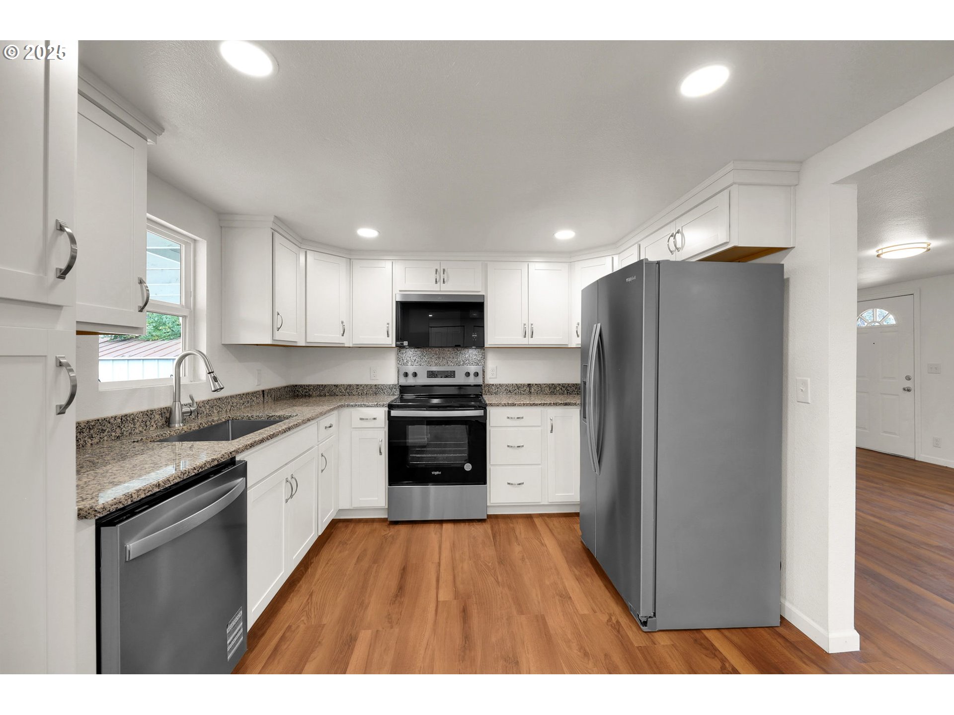 2665 E Street Springfield, OR 97477 - Photo 11 of 37 a kitchen with a refrigerator a sink and cabinets