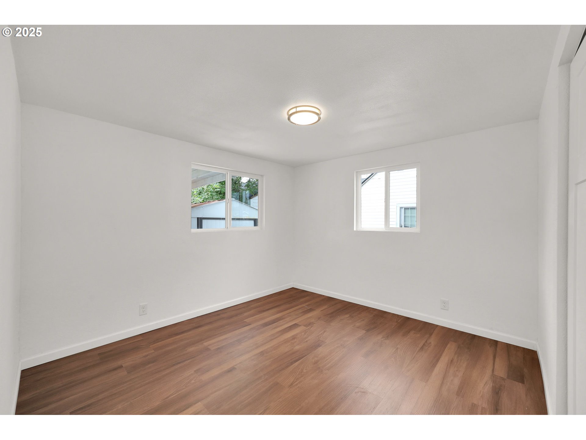 2665 E Street Springfield, OR 97477 - Photo 20 of 37 a view of an empty room with wooden floor and a window