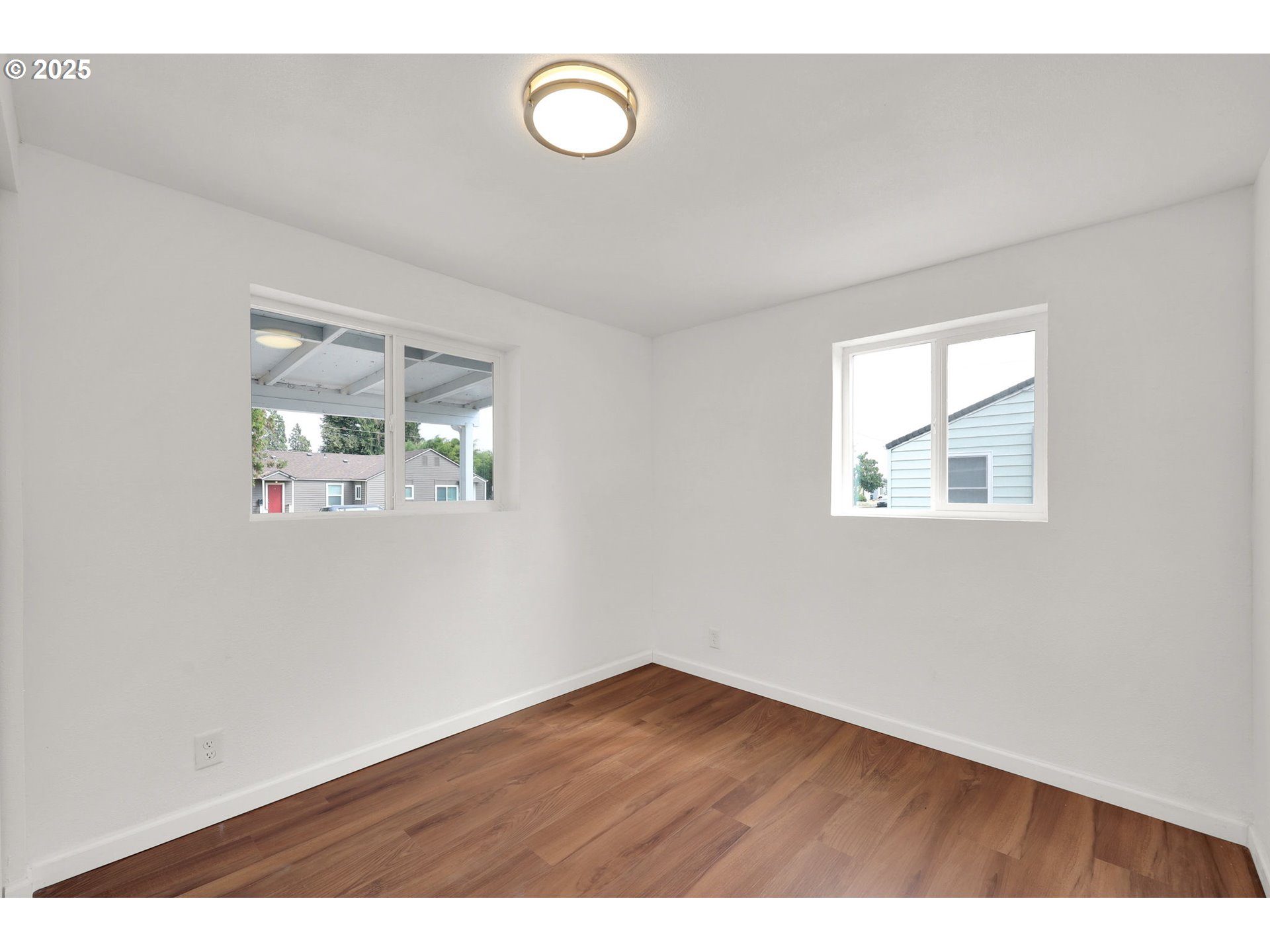 2665 E Street Springfield, OR 97477 - Photo 23 of 37 an empty room with wooden floor and windows