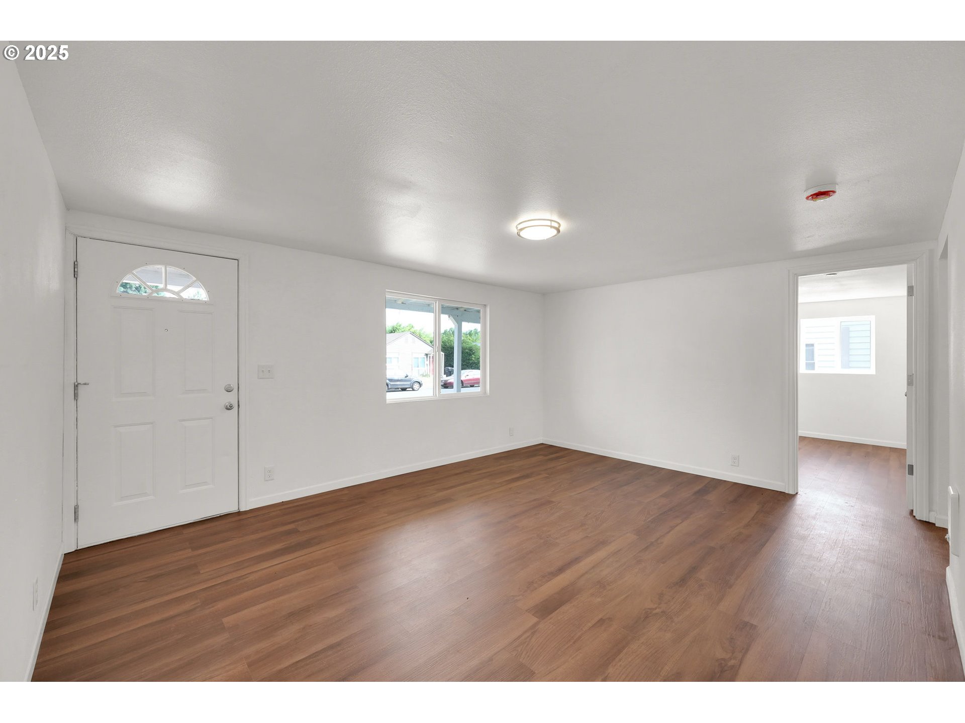 2665 E Street Springfield, OR 97477 - Photo 5 of 37 a view of an empty room with wooden floor and a window