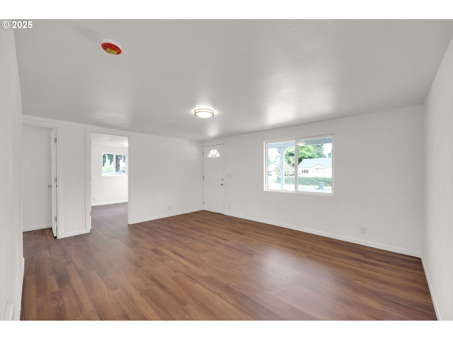 2665 E Street Springfield, OR 97477 - Photo 6 of 37 a view of an empty room with wooden floor and a window