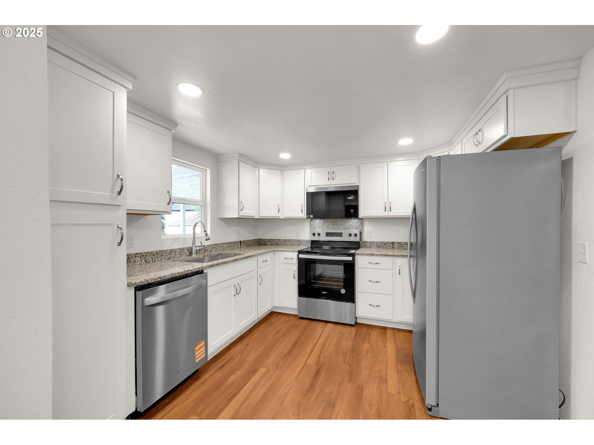 2665 E Street Springfield, OR 97477 - Photo 9 of 37 a kitchen with stainless steel appliances a refrigerator sink and stove