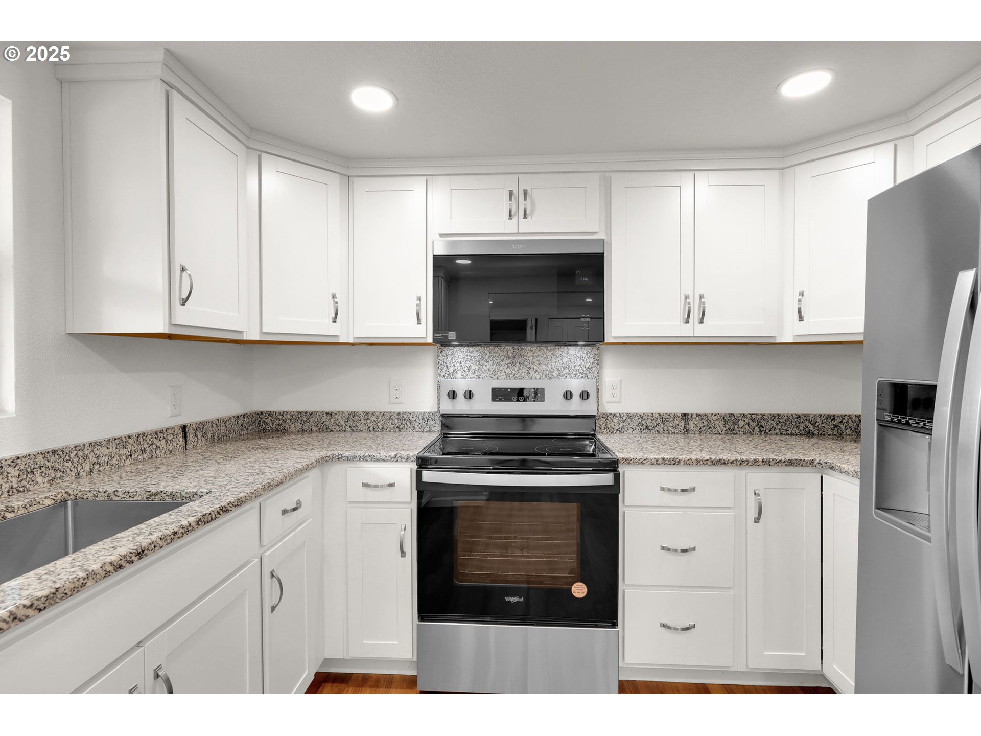 2665 E Street Springfield, OR 97477 - Photo 10 of 37 a kitchen with stainless steel appliances granite countertop a stove a sink and a microwave
