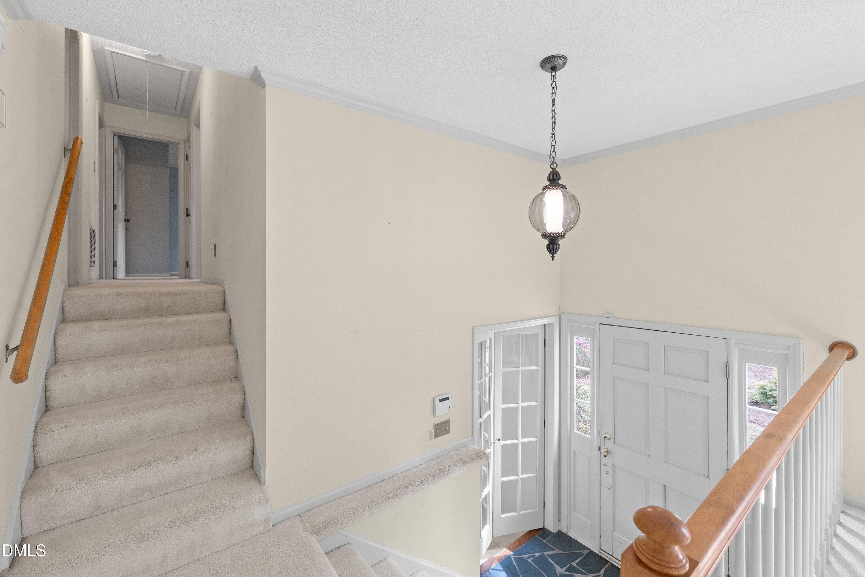 1429 Falls Church Road Raleigh, NC 27609 - Photo 13 of 60 a view of a hallway with entryway wooden floor and windows