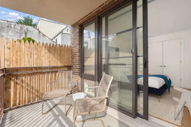 a bedroom with a bed and glass window