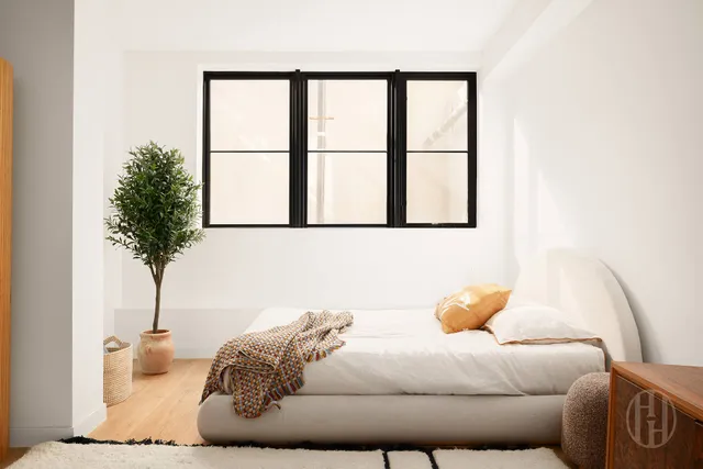 a dining room with furniture and a floor to ceiling window