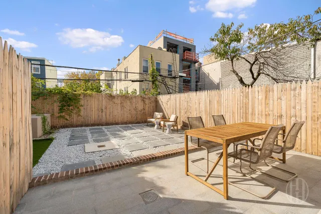 a kitchen with cabinets a sink dining table and chairs