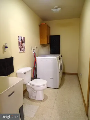 a white toilet sitting next to a bathroom sink