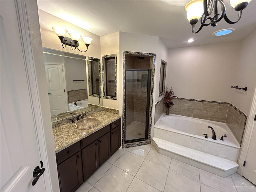 2111 Solar Drive Mission, TX 78574 - Photo 17 of 20 a bathroom with a granite countertop sink a toilet and bathtub