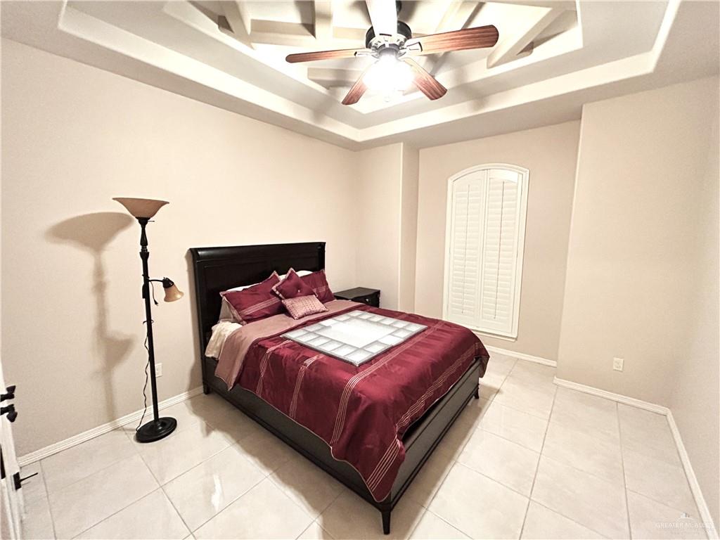 2111 Solar Drive Mission, TX 78574 - Photo 7 of 20 a bedroom with a bed and a chandelier