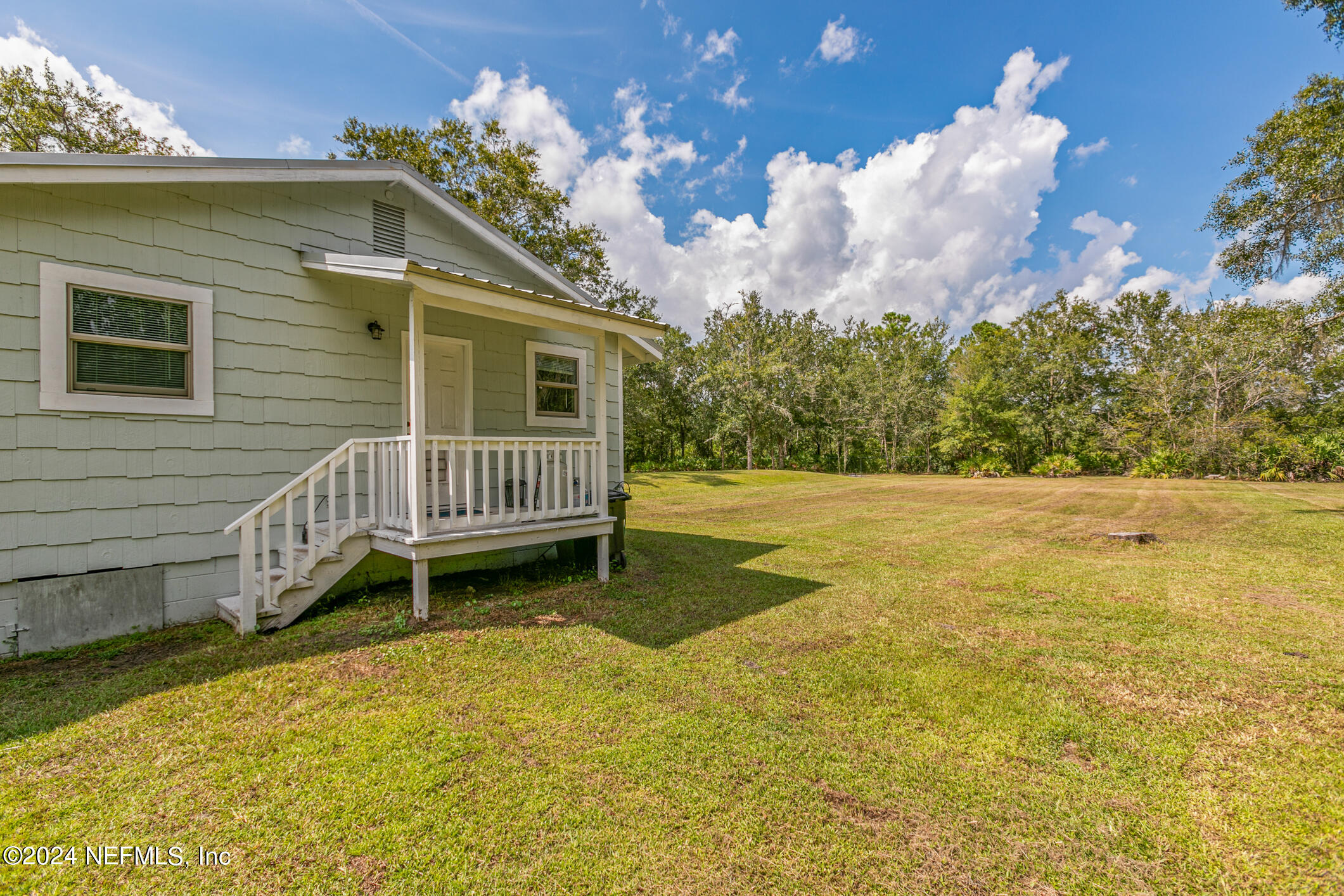 1151 Carter Road Lawtey, FL 32058 - Photo 29 of 47 a backyard of a house with table and chairs
