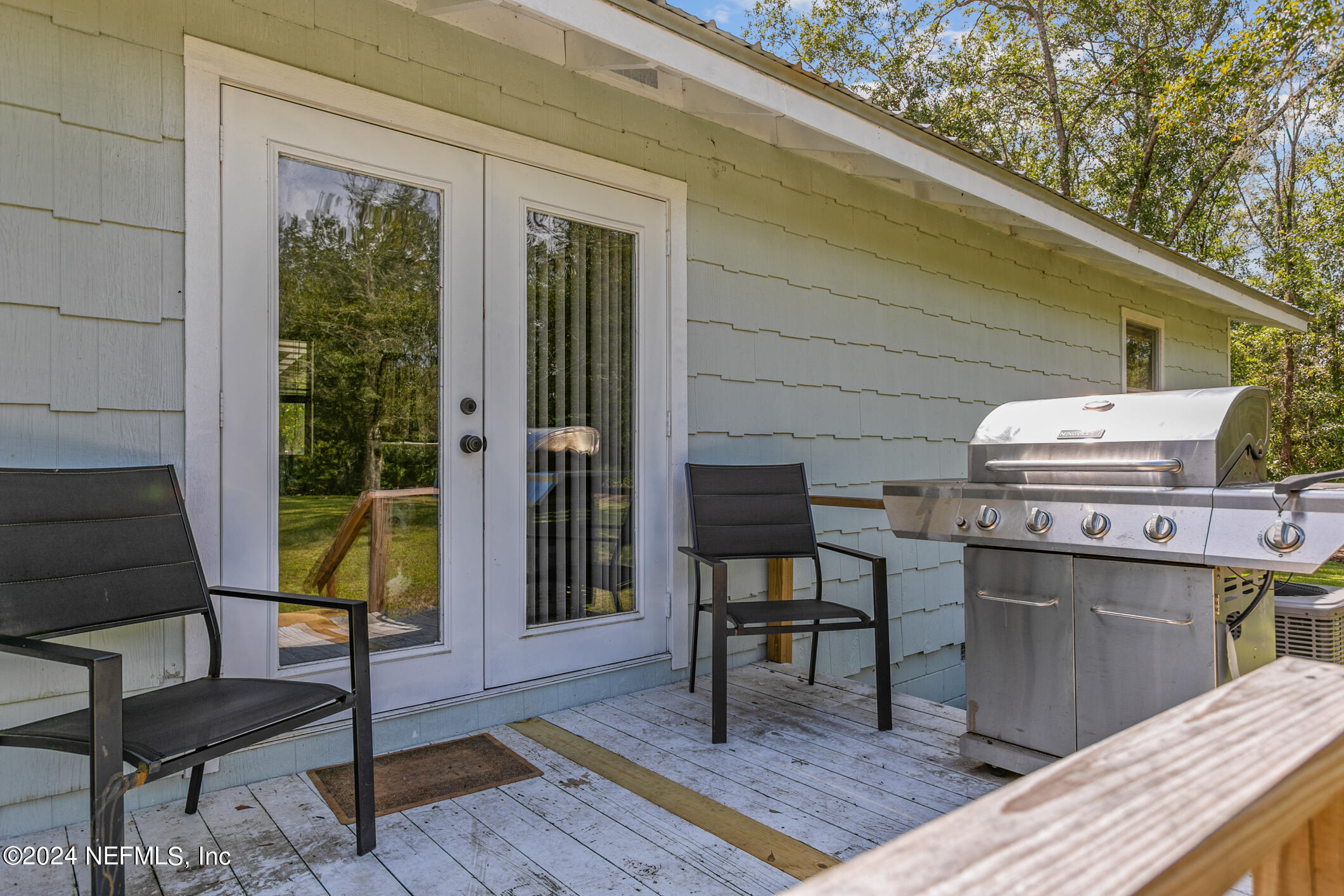 1151 Carter Road Lawtey, FL 32058 - Photo 32 of 47 a view of a chairs and table in backyard of the house