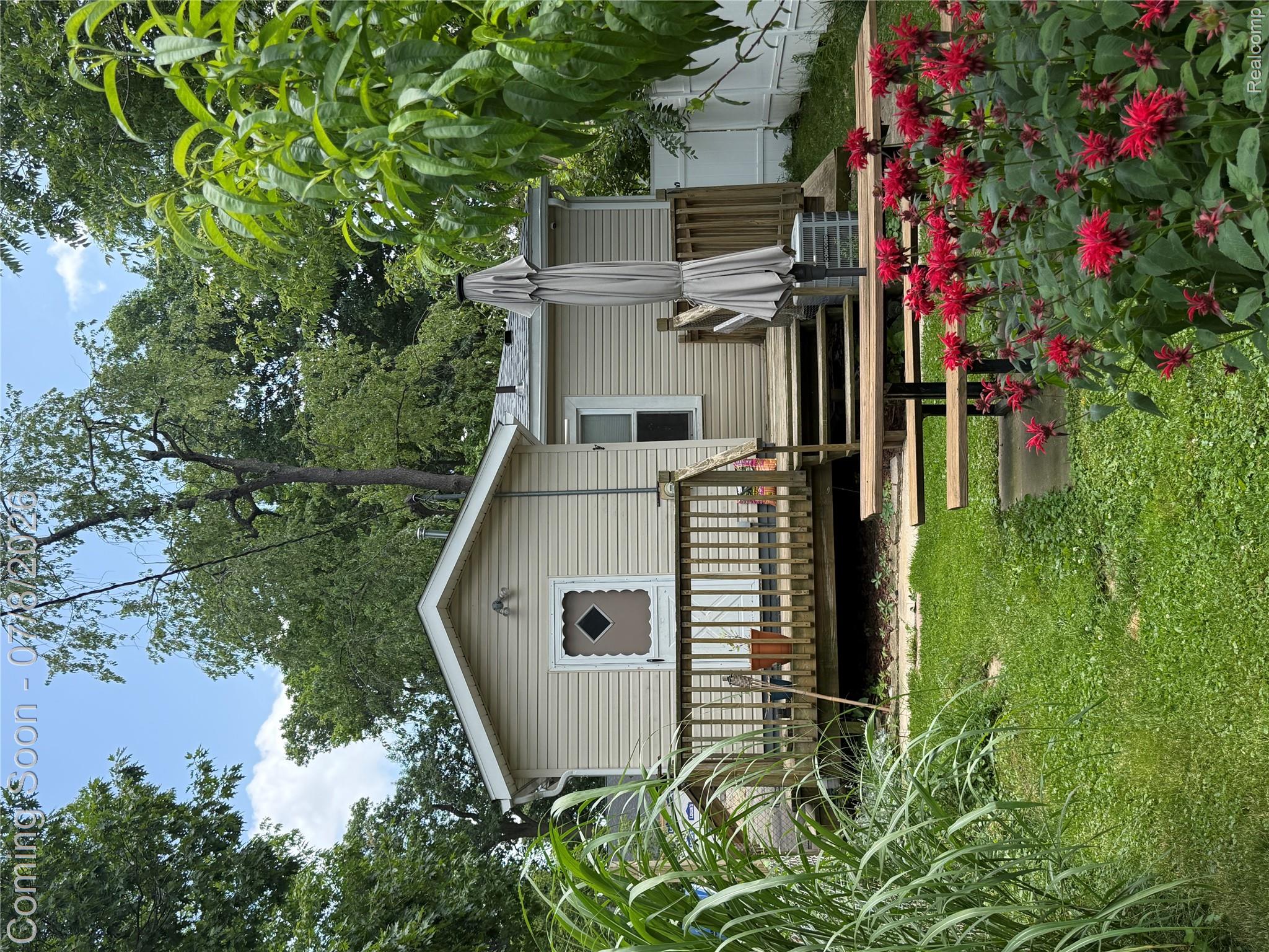 756 Cedarlawn Road Waterford, MI 48328 - Photo 30 of 34 Exterior featuring neutral siding, a gabled roofline, and a wooden deck