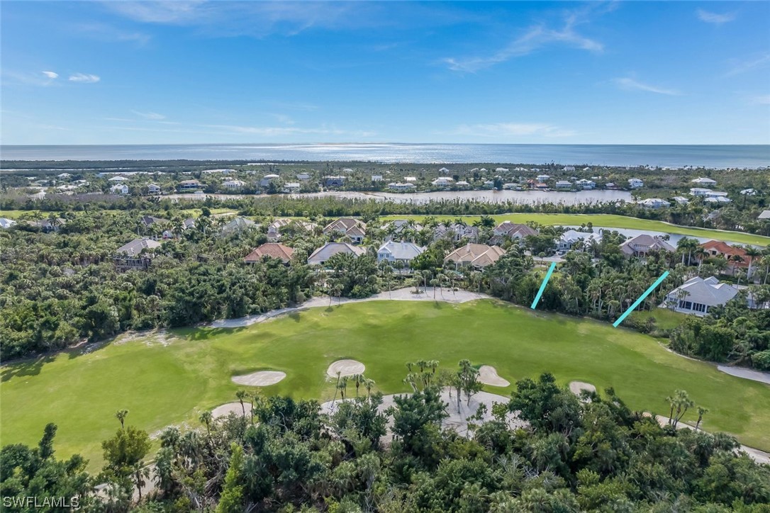 2438 Wulfert Road Sanibel, FL 33957 - Photo 2 of 21 an aerial view of ocean with residential houses with outdoor space and trees