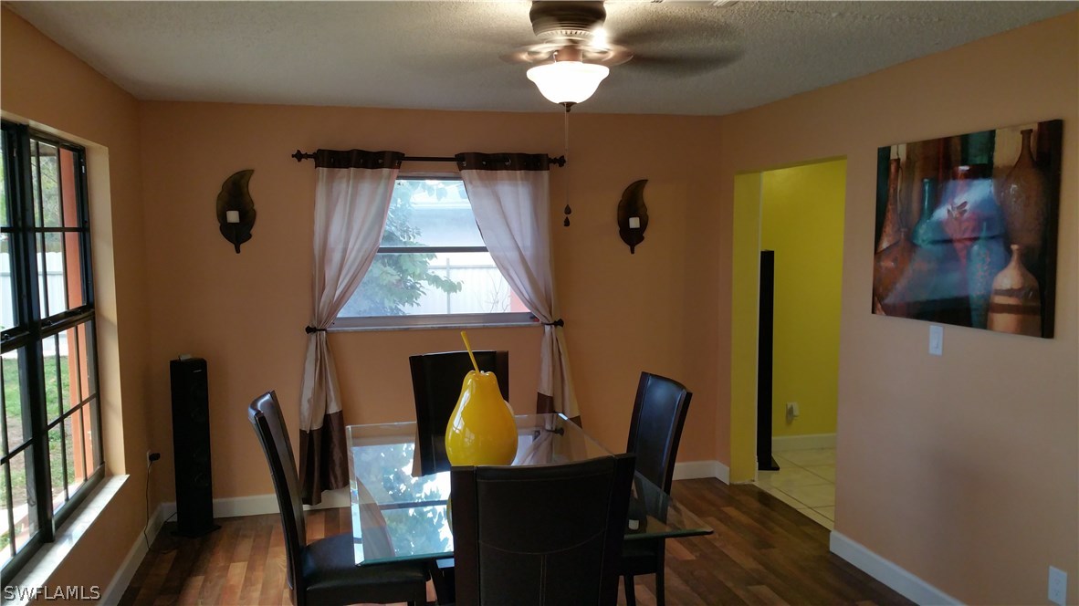 24 Colorado Road Lehigh Acres, FL 33936 - Photo 11 of 12 a view of a dining room with furniture window and wooden floor