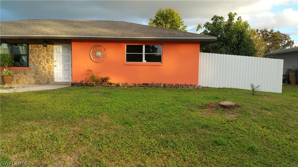 24 Colorado Road Lehigh Acres, FL 33936 - Photo 2 of 12 a backyard of a house with lots of green space