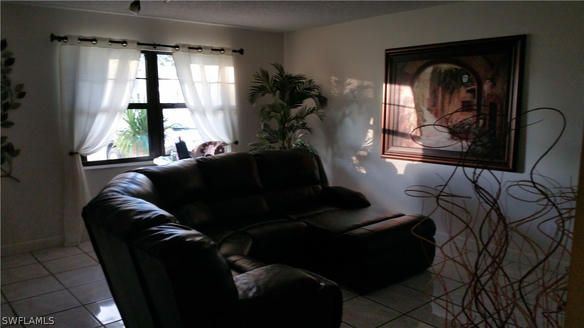 24 Colorado Road Lehigh Acres, FL 33936 - Photo 3 of 12 a living room with furniture and a window