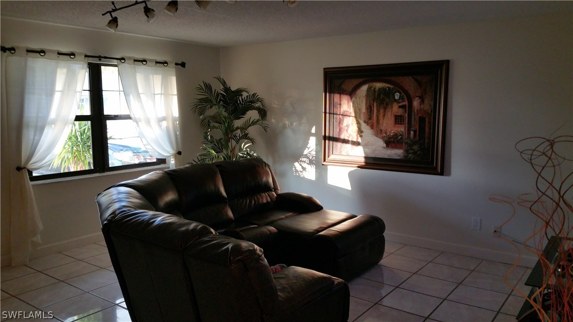 24 Colorado Road Lehigh Acres, FL 33936 - Photo 4 of 12 a living room with furniture and a window