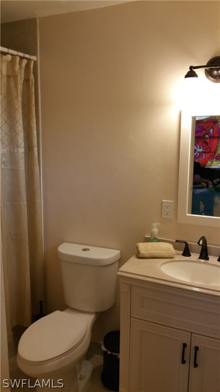 24 Colorado Road Lehigh Acres, FL 33936 - Photo 6 of 12 a white toilet sitting next to a bathroom sink
