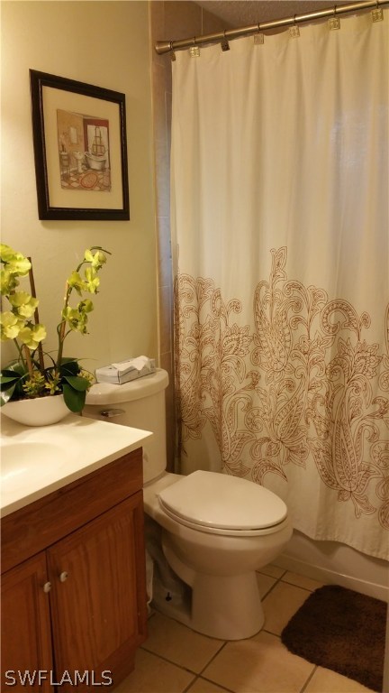 24 Colorado Road Lehigh Acres, FL 33936 - Photo 8 of 12 a bathroom with a toilet a sink and a shower curtain