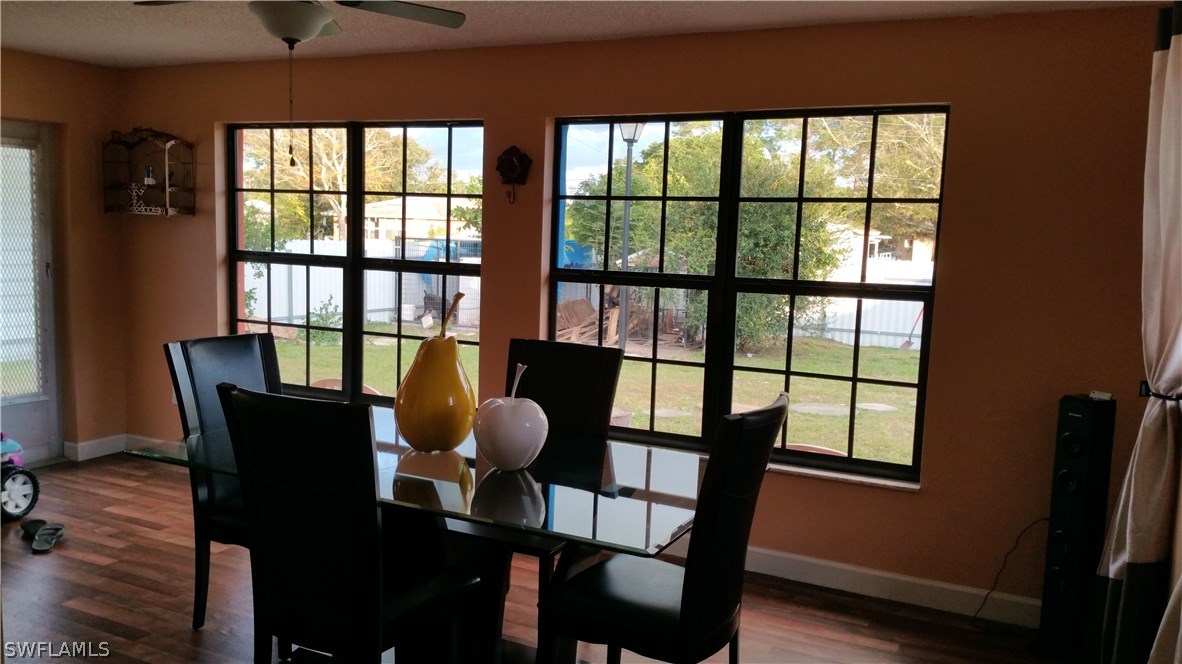 24 Colorado Road Lehigh Acres, FL 33936 - Photo 10 of 12 a view of a dining room with furniture window and wooden floor