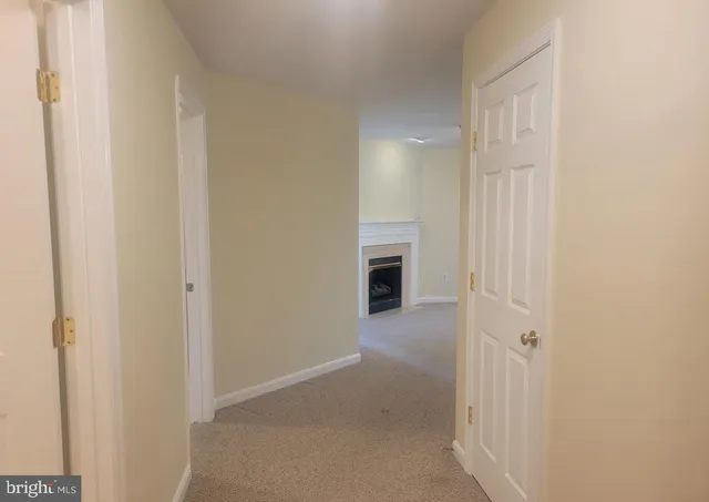 a view of an empty room with a fireplace