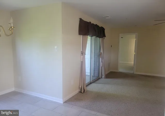 an empty room with windows and wooden door