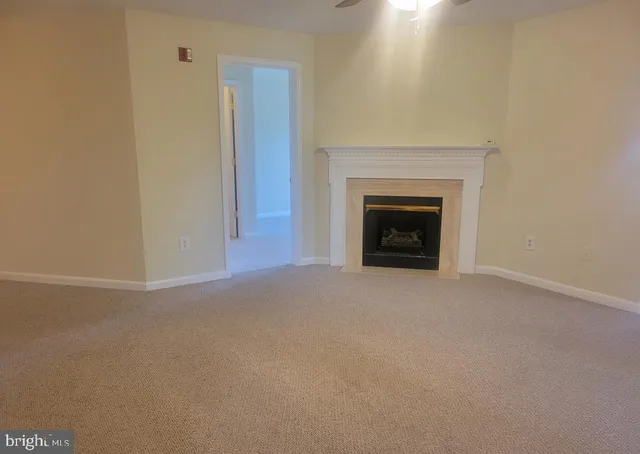 a view of empty room with a fireplace