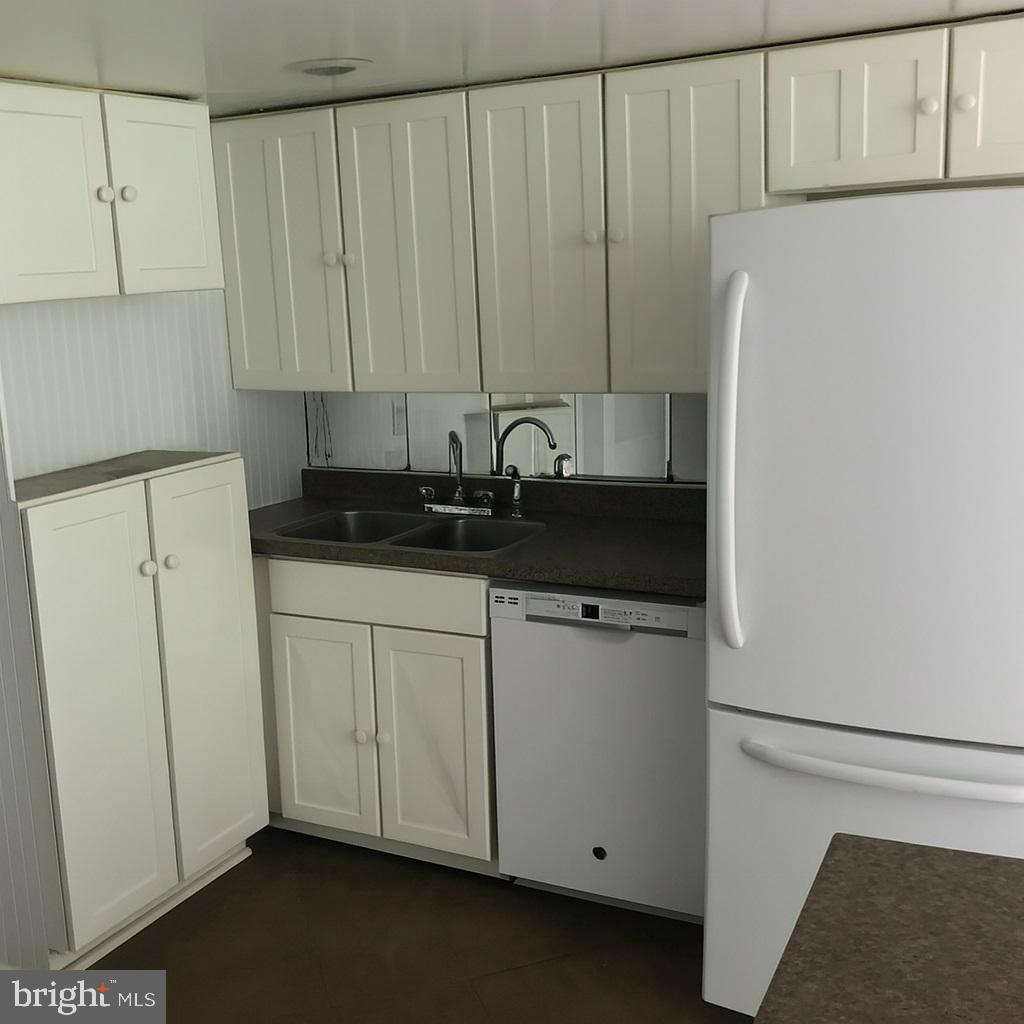 2906 Needmore Road Baker, WV 26801 - Photo 13 of 22 a view of a kitchen with refrigerator and cabinet