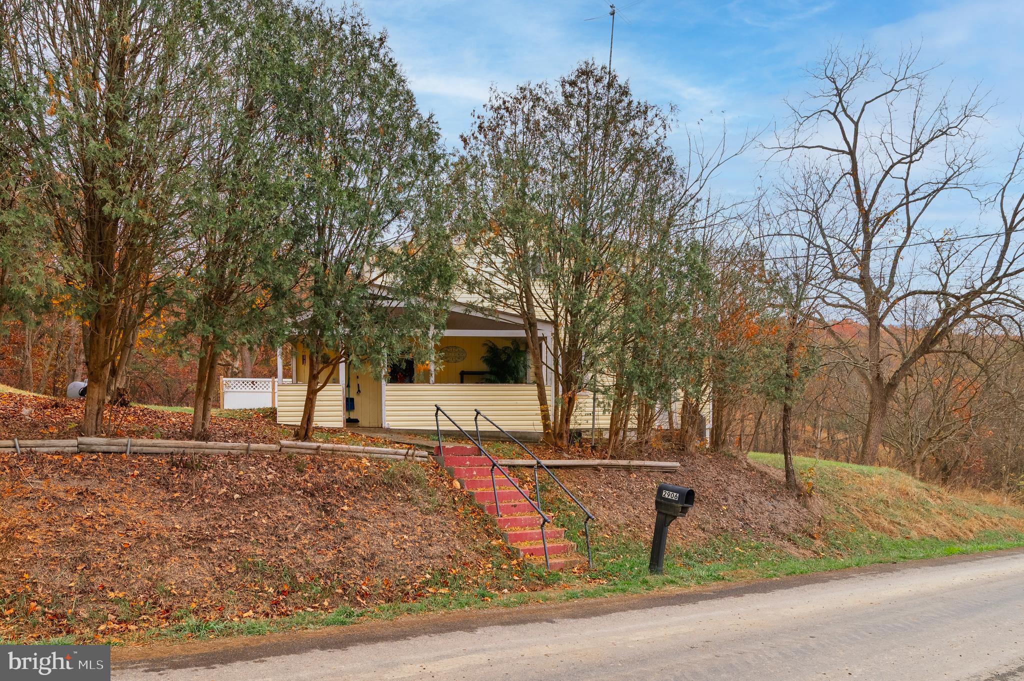 2906 Needmore Road Baker, WV 26801 - Photo 2 of 22 a front view of a house with garden