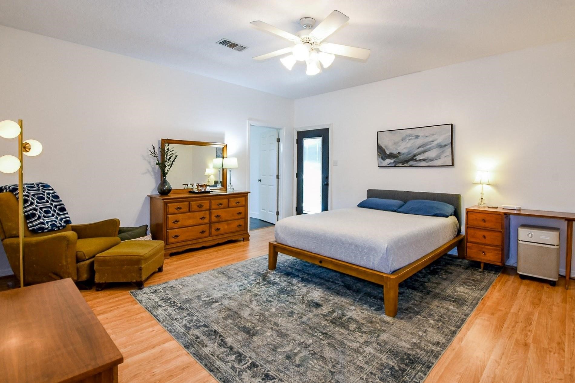 22035 Buescher Road Tomball, TX 77377 - Photo 20 of 43 a bedroom with a bed and wooden floor